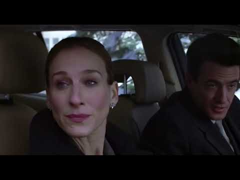 Trailer frame — quiet living room moment under Christmas lights, echoing the score’s intimate palette