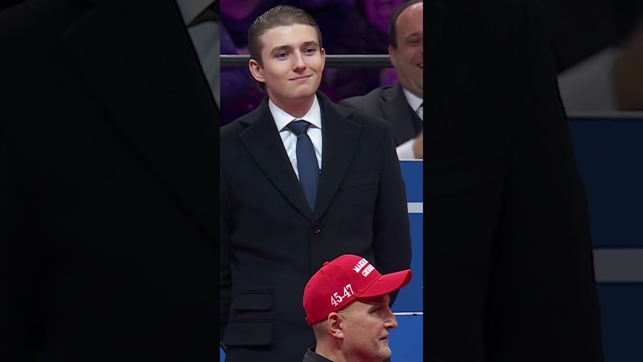 Barron Trump reacts to the crowd after dad acknowledges him at inauguration