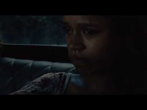 Nighttime trailer image of carnival lights and distant figures