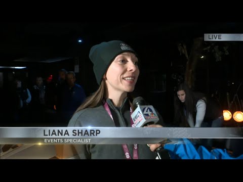 Community members donate to the Stuff the Bus event