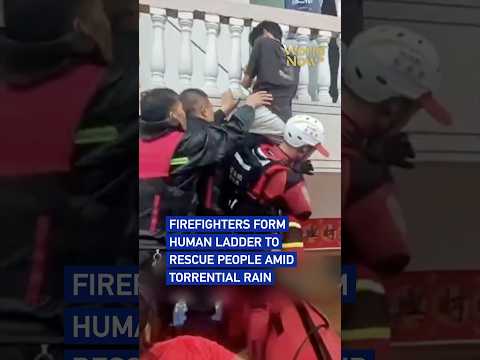 Firefighters form human ladder to rescue people amid torrential rain #worldnow