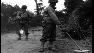 US Army soldiers of 29th Division walk on a dirt road in Saint Lo France, searchi...HD Stock Footage