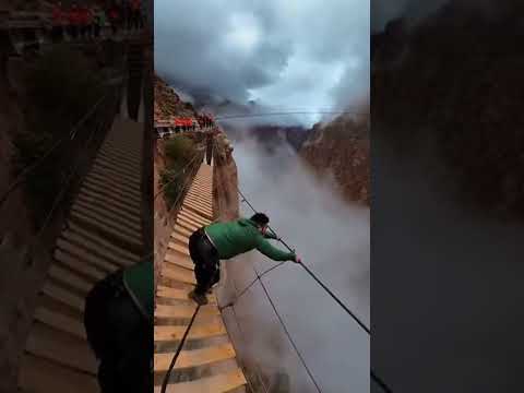 Hanging Bridge Starts Collapsing Over a Cliff… He’s Saved Only by the Safety Line ⛰️