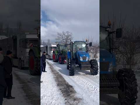 TRACTORS ARE PULLING THE TRUCK.