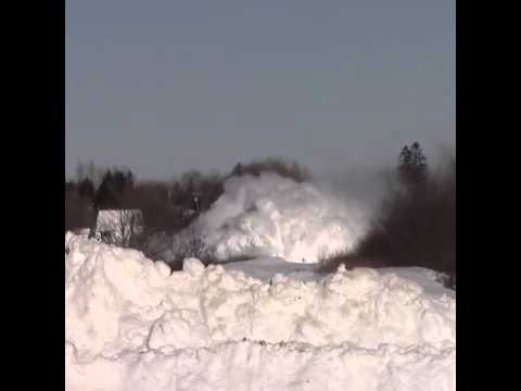 Train plows through snow bank