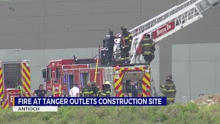 Crews work to extinguish fire at Tanger Outlets construction site