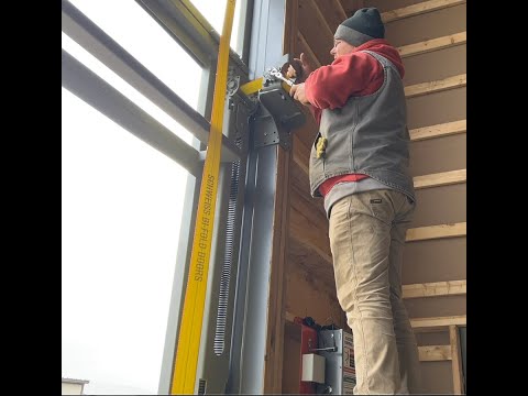 Schweiss Crew Installs Strap Latch on 50' x 18' Strap Bifold Door
