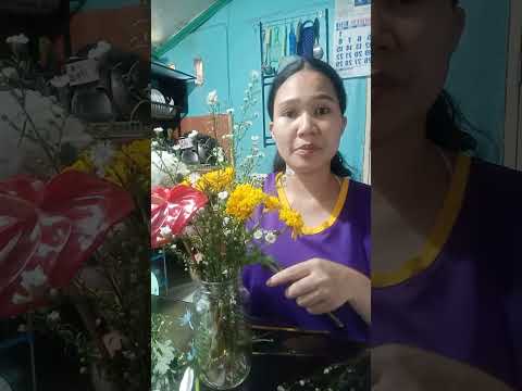 ARRANGING FLOWERS BOUGHT BY MOTHER AT THE CHURCH TO PUT IN THE ALTAR