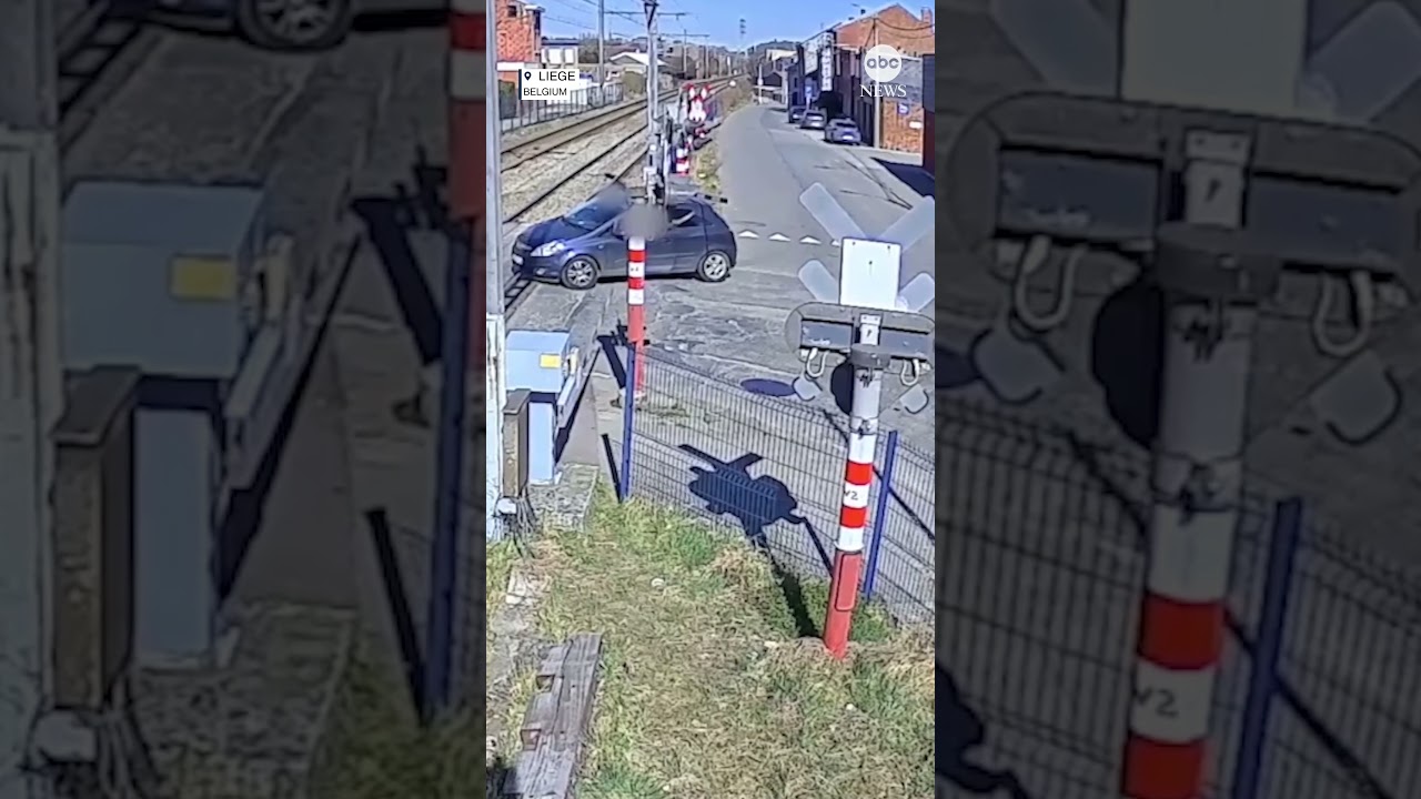 Two people escape car stuck on tracks moments before train plows into vehicle