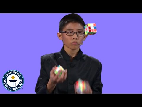 He JUGGLED and SOLVED 3 Rubik's cubes! - Guinness World Records