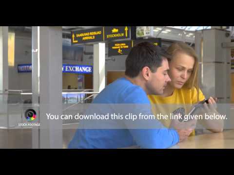 Happy Couple View Photos In Smart Phone