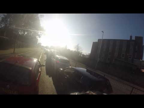 Stupid driver of red Renalt clio cuts off cyclist while in traffic LV03 EZJ