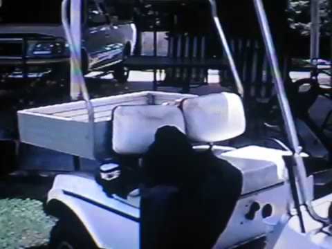 2001 08 10   Brunette sitting on the golf cart returned from fishing!   10 00 AM CST