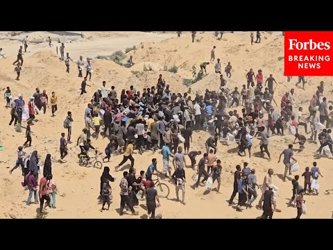 Palestinians Run To Aid Airdrop In Gaza Amid United Nations Report Of Famine