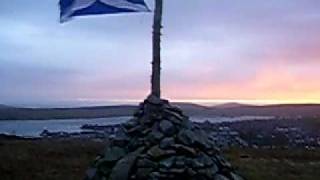 lerwick,shetland staney hill over looking lerwick town scotland flag with pink sky..MOV