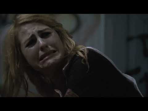 Halloween II (2009) official trailer frame: Michael in rain-soaked night outside Haddonfield