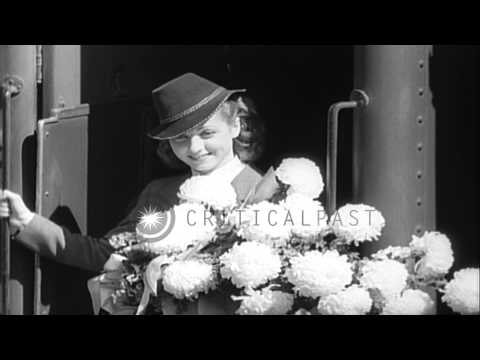 People gather at the rail road station to greet the French actress Danielle Darri...HD Stock Footage