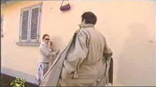 A woman trips and her handbag flies into the air and then gets caught on a hook