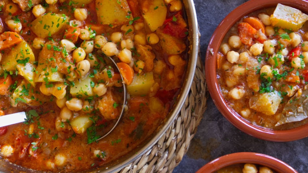 a pot of chickpea stew is served to 2 smaller bowls
