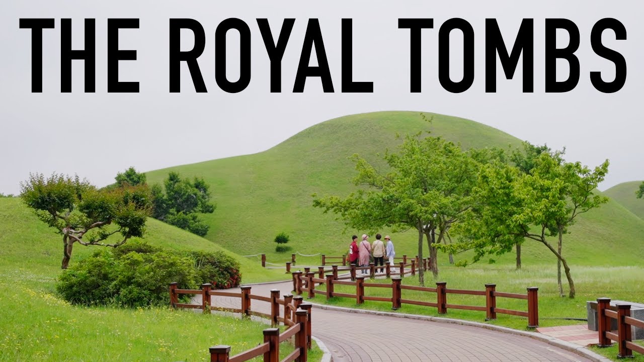 The historic city of Gyeongju South Korea showing ancient Silla dynasty royal tomb mounds in a grassy park with mountains in the distance