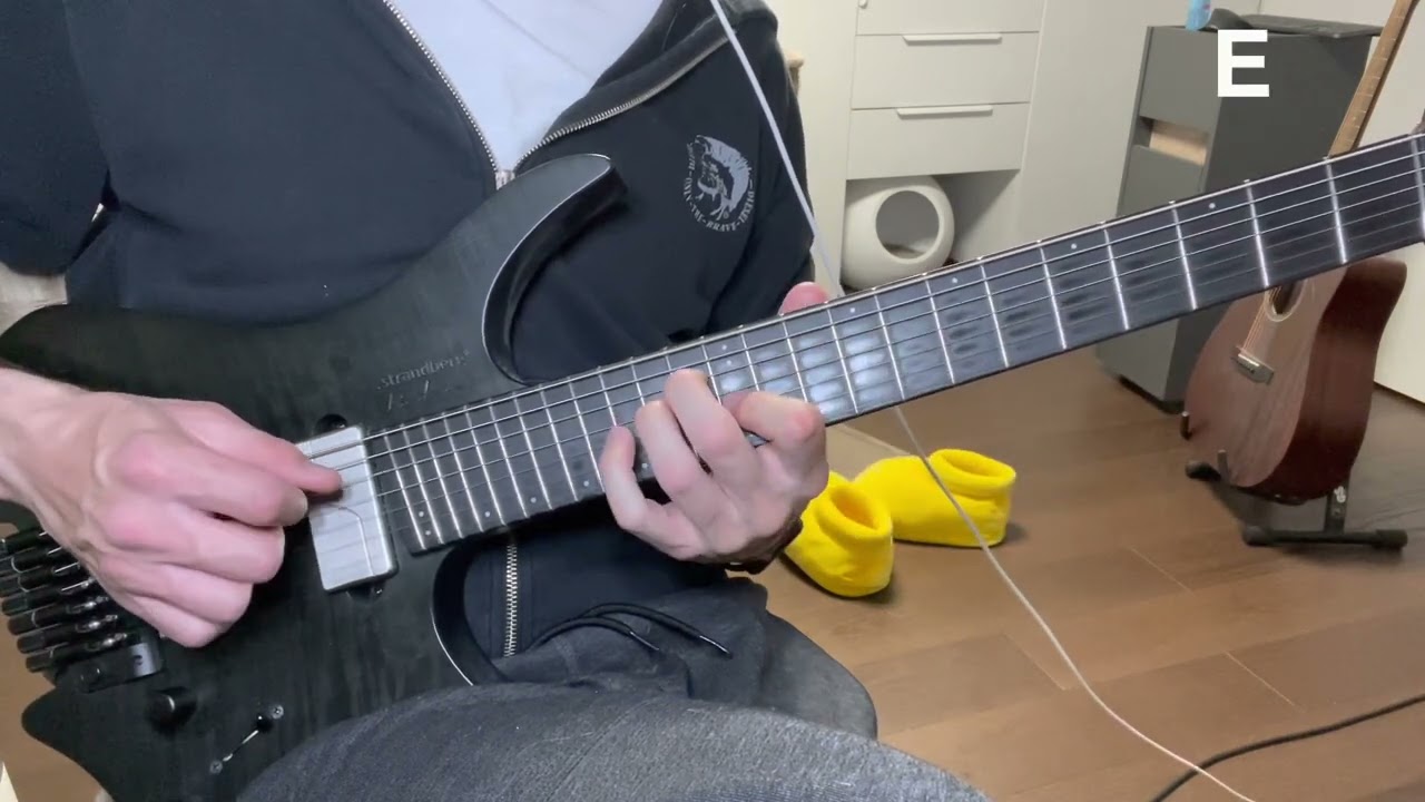 Hands playing diminished triads on the G, D and A strings of a guitar fretboard