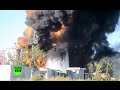 RAW: Firefighters battle huge oil depot blaze in ...