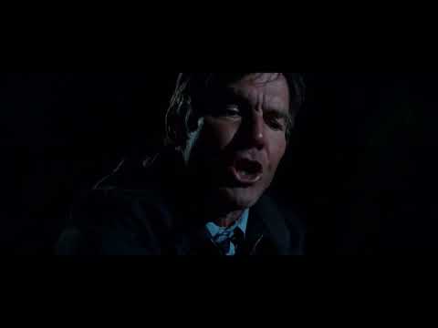 Trailer frame: teens creeping through a house, flashlight beam cutting through darkness