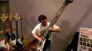 Dude rocks out on a monster sized Flying V guitar.