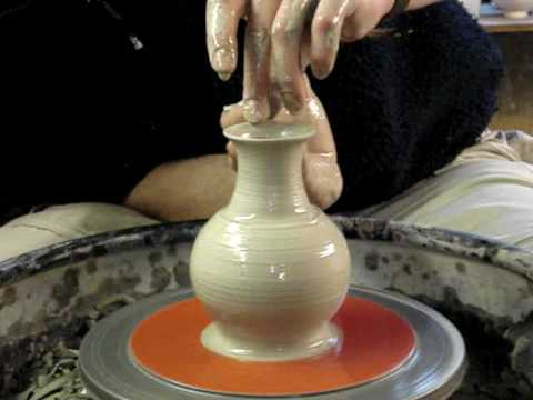 Throwing a small clay pottery bottle vase on a wheel demo how to