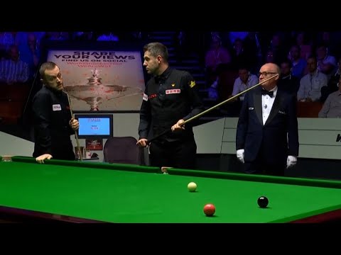 Mark Allen stands over Mark Selby to hurry him up