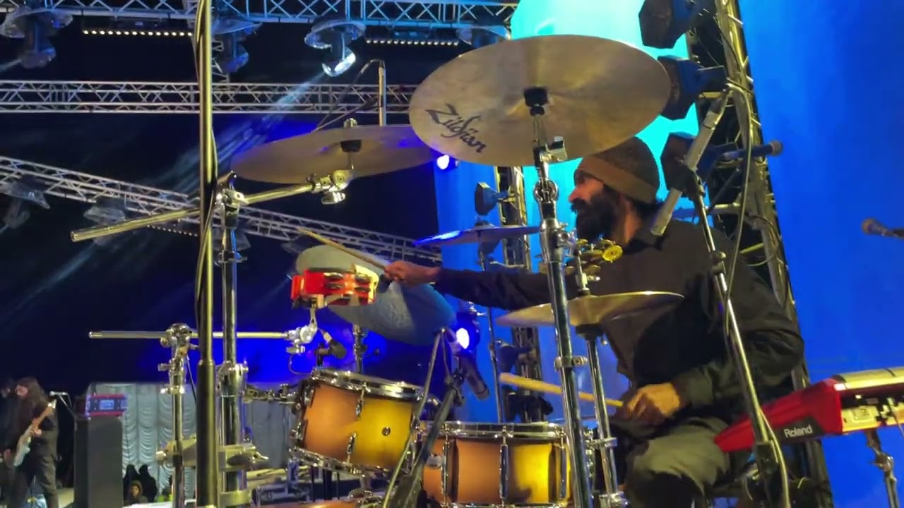Nikhil Vasudevan playing drums during a live performance