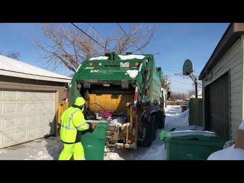 Waste Management McNeilus Rear Loader Garbage Truck in a Snowy Alley