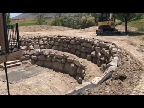 Rock Retaining Wall Construction with Yanmar VIO 55 and ASV Compact Track Loader.