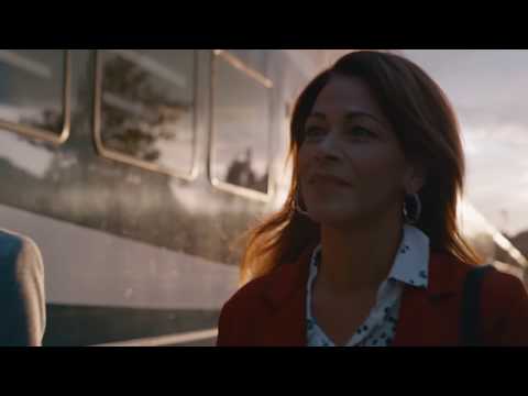 Lady alongside a Rocky Mountaineer train