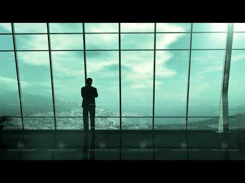 A silhouette of a businessman standing in front of a window from dawn to dusk