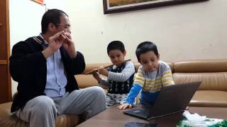 5 year old Oc enjoys playing bamboo flute with his dad