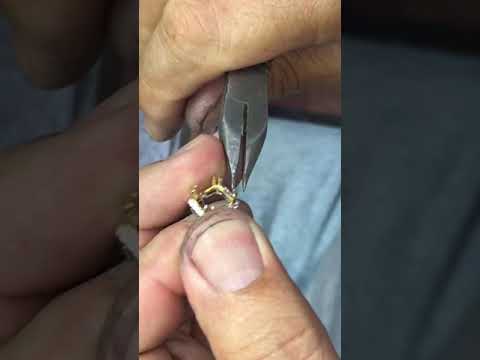 Hand making a emerald and diamond gold tennis bracelet