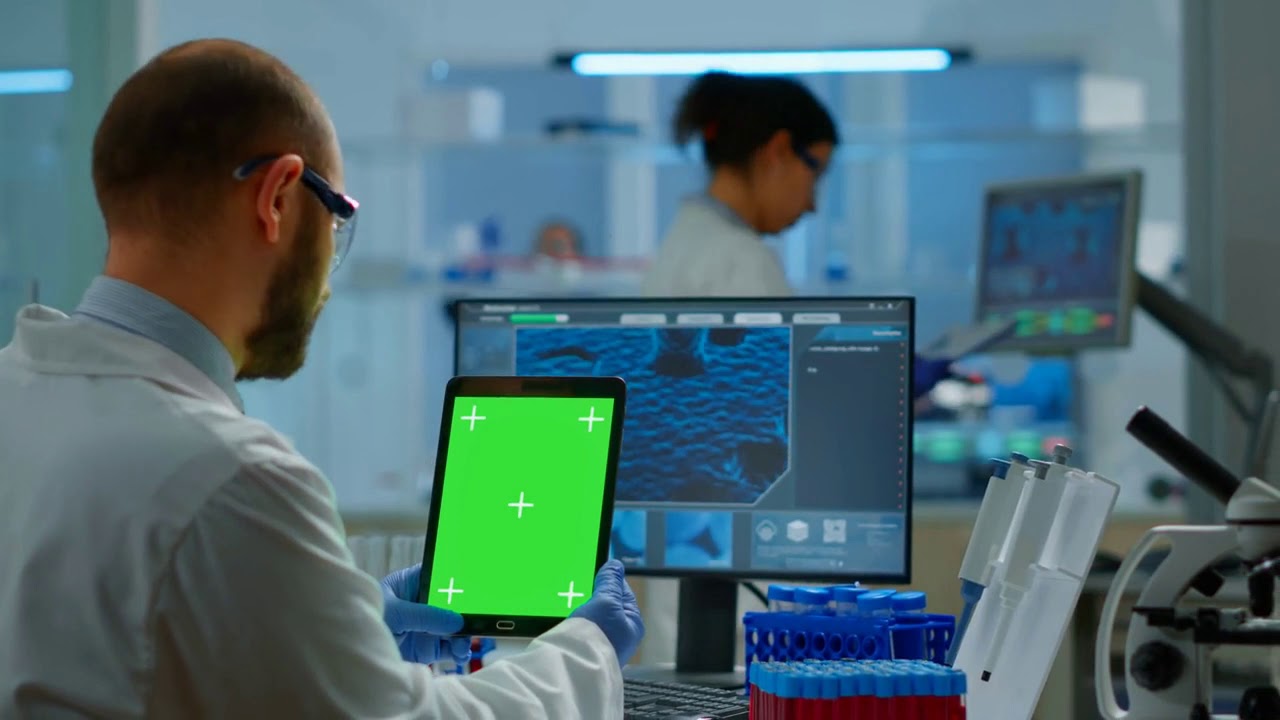 Man doctor holding tablet with green screen