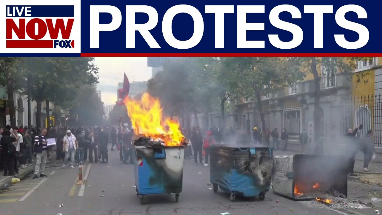 Protesters set dumpster on fire in Albania
