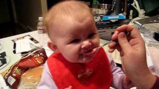 Babies first baby food feeding, baby making funny "yucky" faces