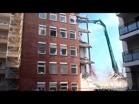 GIANT EXCAVATOR EATING LARGE BUILDING DEMOLITION CONSTRUCTION SITE