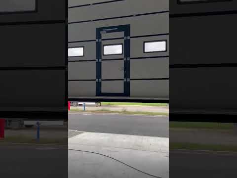 logistic area sectional door with integrated service door