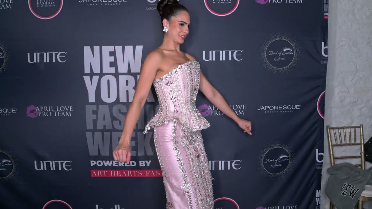 Miss Global Cuba 2024 @Freddrareyes wearing Giannina Azar poses for a fan at @ArtHeartsFashion NYFW