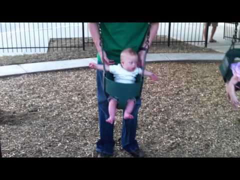 Ver vídeo Down Syndrome kid playing on a swing set