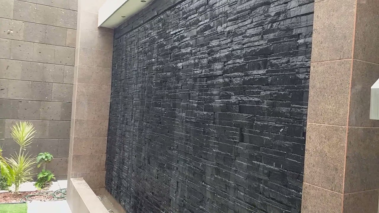 instalación de cantera y piedra prefabricada sobre muro lloron