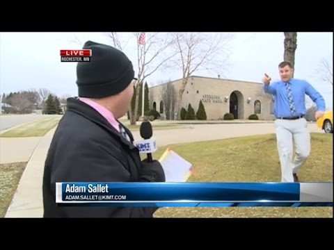 Watch a Bank Robber Interrupt This News Reporter During Live Broadcast