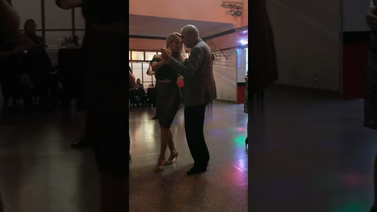 tango dance at dance floor of Buenos Aires milonga. Carlos Neuman and Veronica