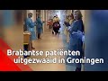 Twee Brabantse patiënten worden uitgezwaaid door het ziekenhuispersoneel in Groningen