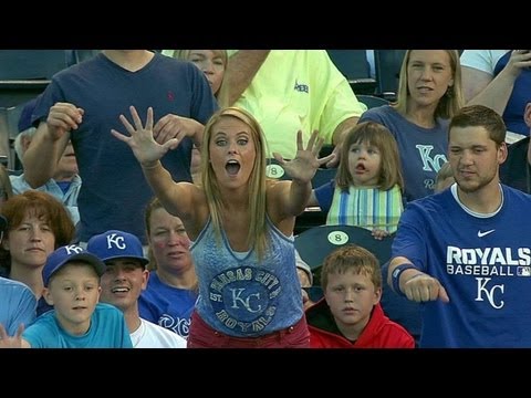 Kid snags souvenir from lady at the ballgame