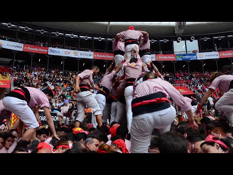 Young Girl Climbing To The Top Of A Human Tower Of Tarragona In Spain